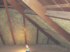 Attic photograph: roof rafters and insulation between joists
